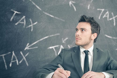 man with tax written behind him