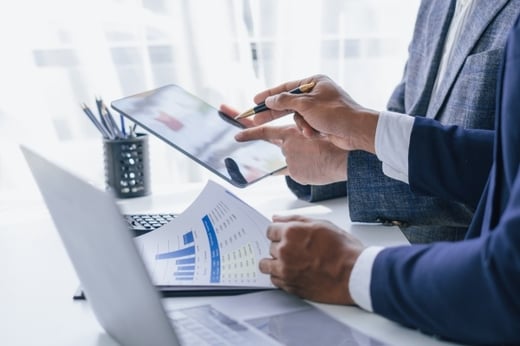 Two financial advisors looking at investment reports together.