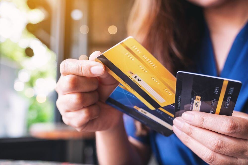 Closeup image of a woman holding and choosing credit card to use.