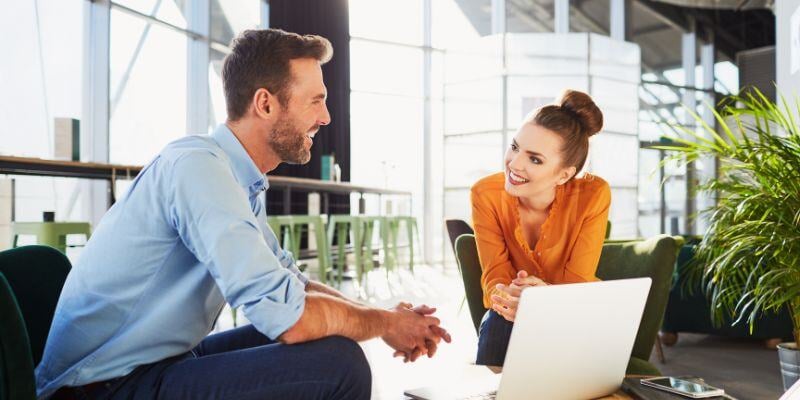 smiling man and woman having a meeting