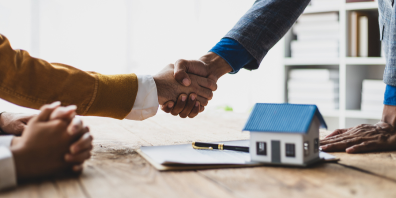 Two people shaking hands on a mortgage deal